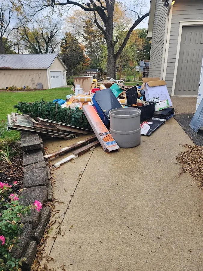 Dumpster being loaded with debris for 3 Yard Dumpster Rental in Land O' Lakes